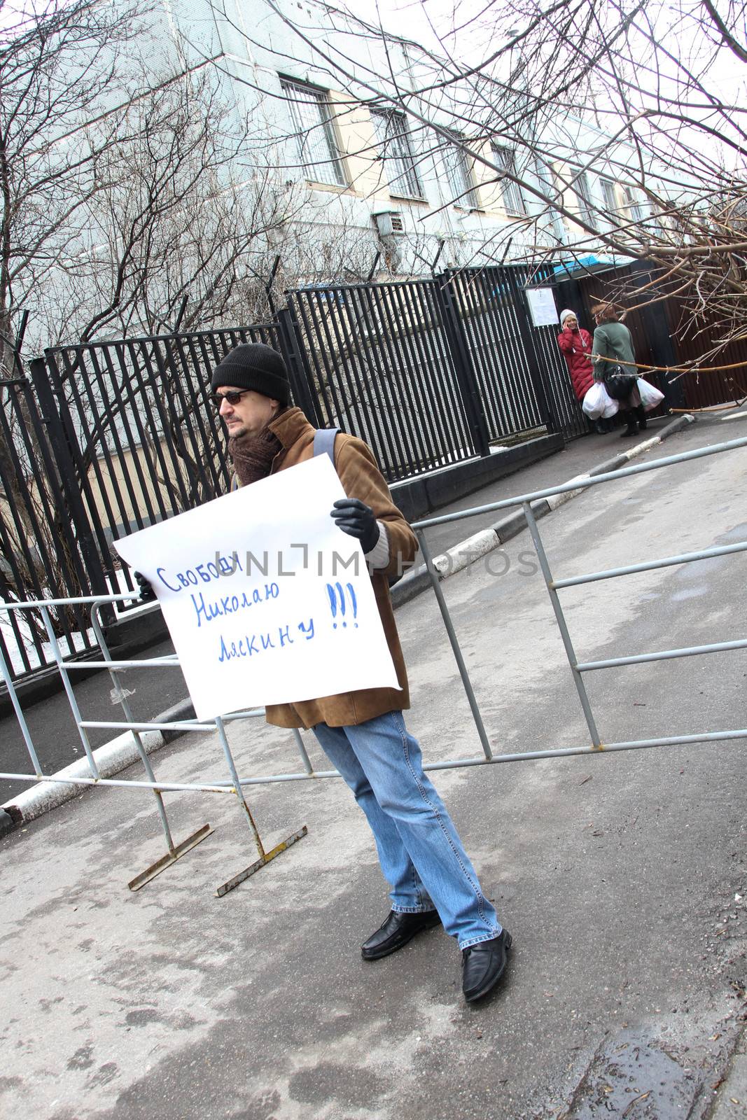 Moscow, Russia - April 10, 2012. The political activist with the poster Freedom to Nikolay Lyaskin near prison where it contains. Liyaskin was detained for attempt to ustnovit protest tent on the Red Square