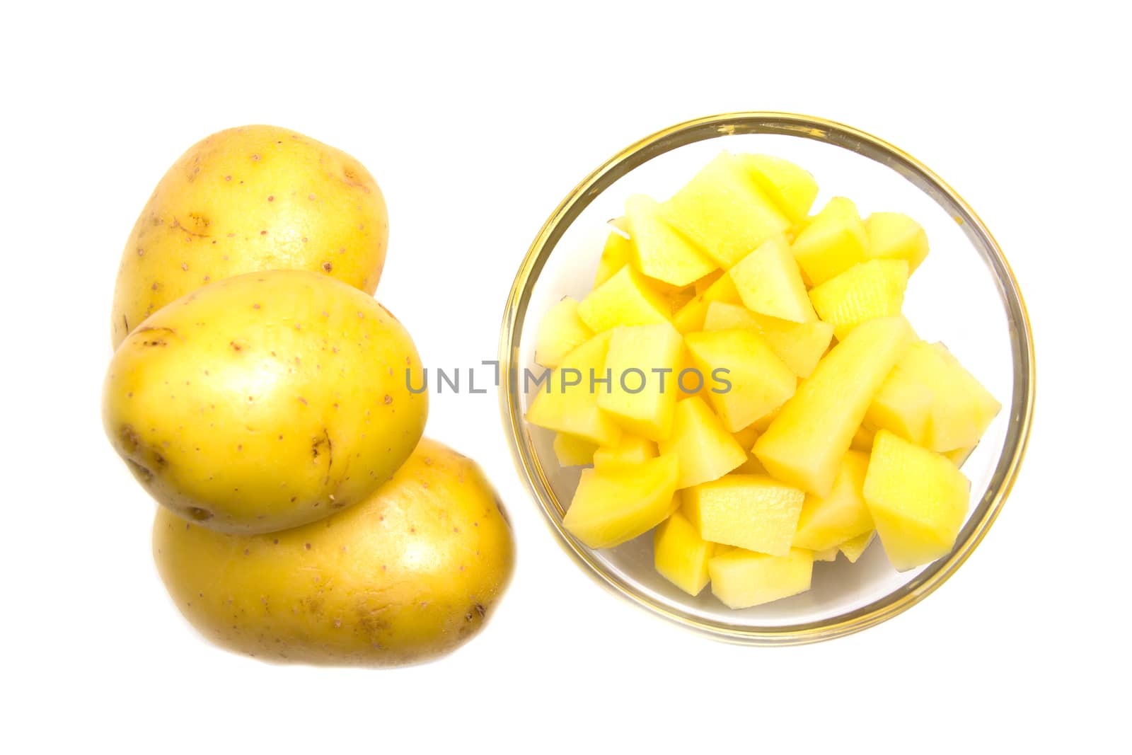 Bowl with potato cubes on white background top view