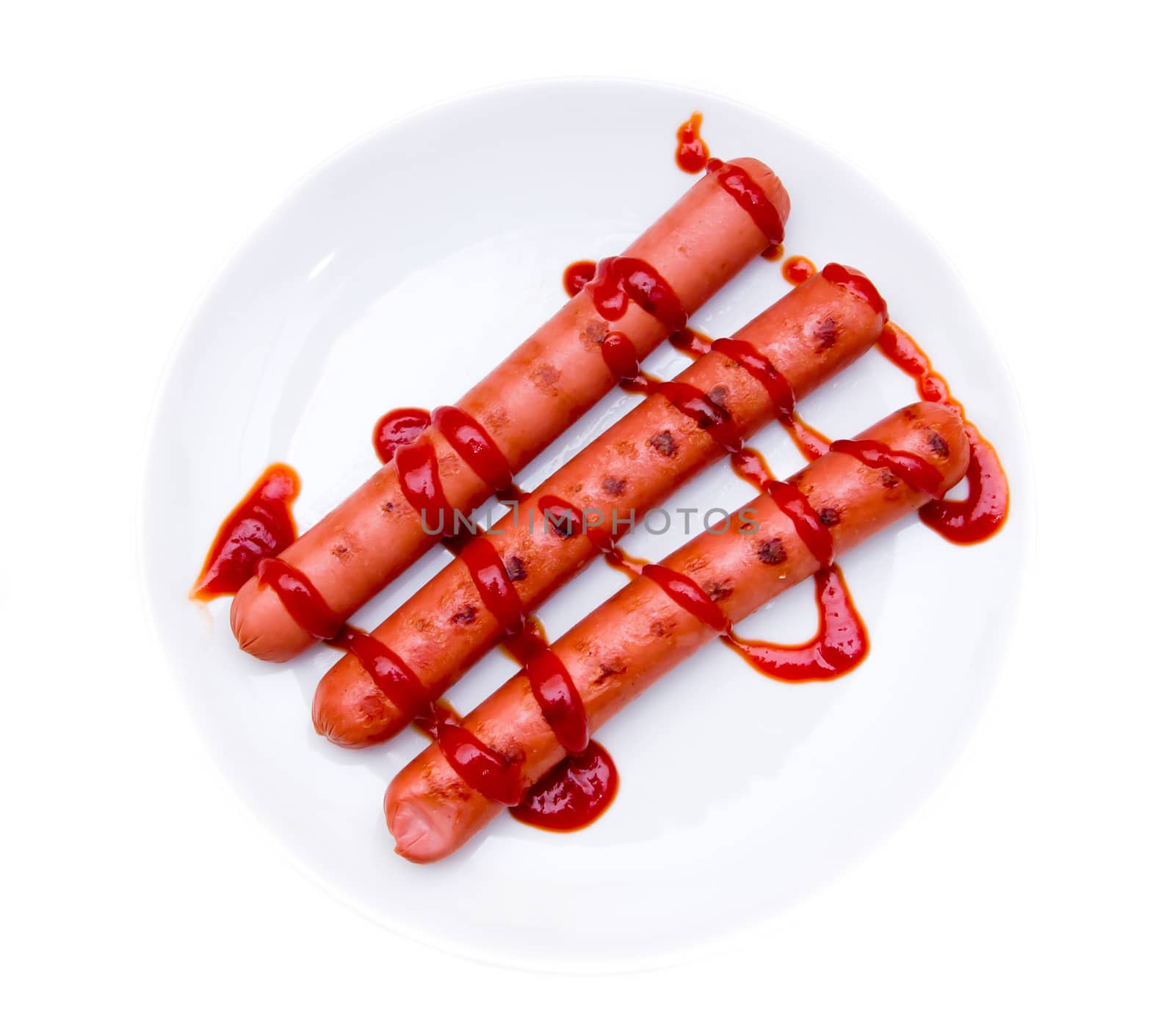 Sausages with tomato sauce on white background viewed from above
