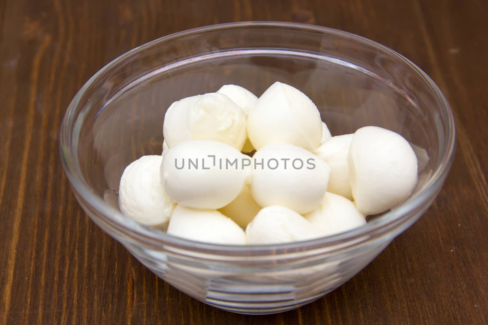 Small Mozzarella inside bowl on wood by spafra