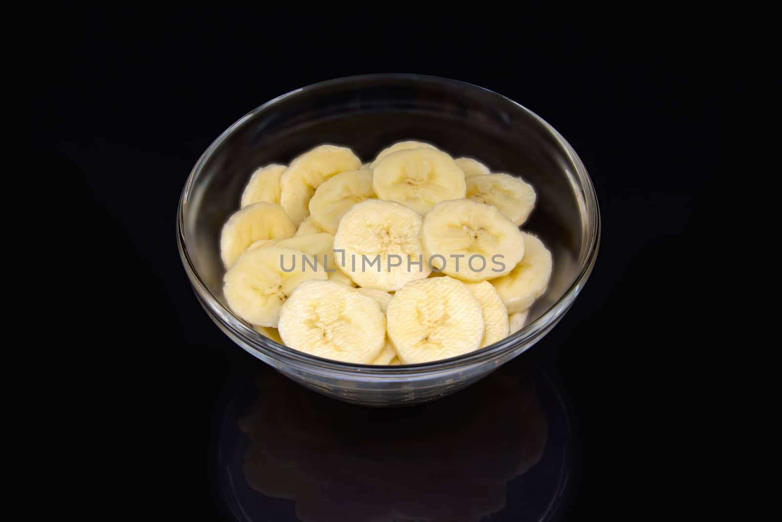 Banana on bowl on black by spafra