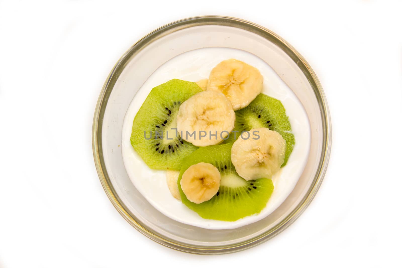 Yogurt with kiwi and banana on a white background seen from above
