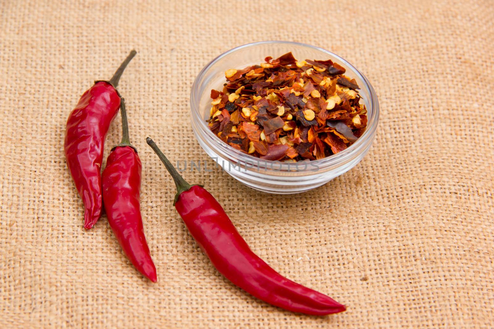 Whole chillies and jute mat on the ground