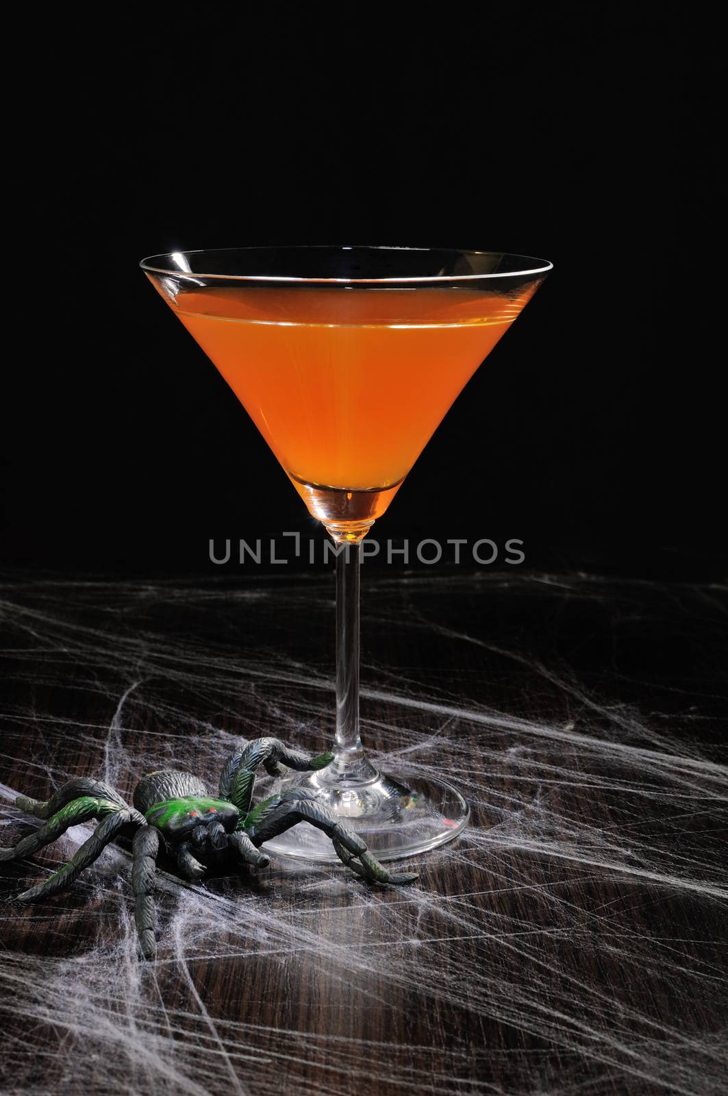 Orange cocktail in a glass on Halloween