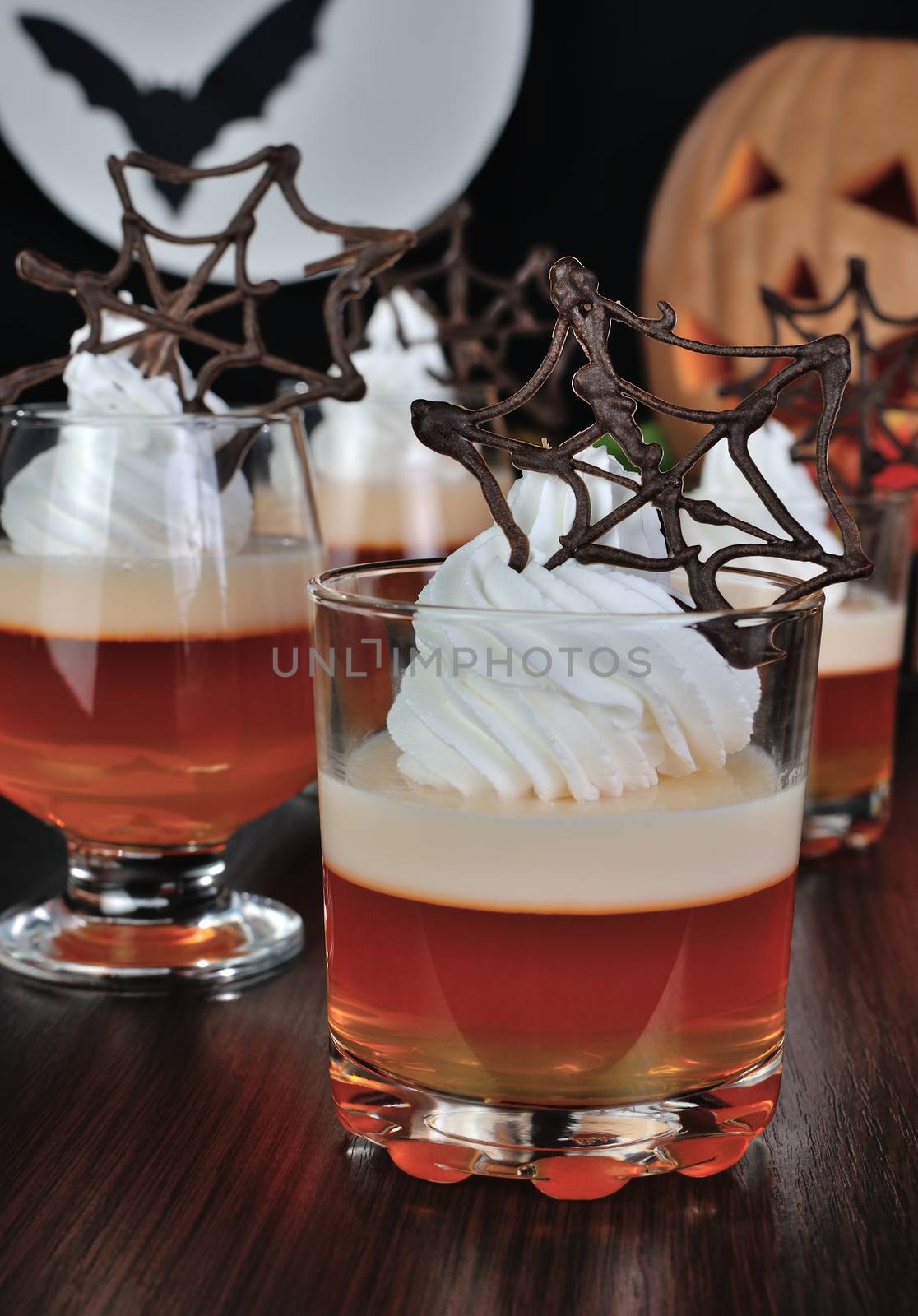 Jelly dessert with cream and chocolate cobwebs