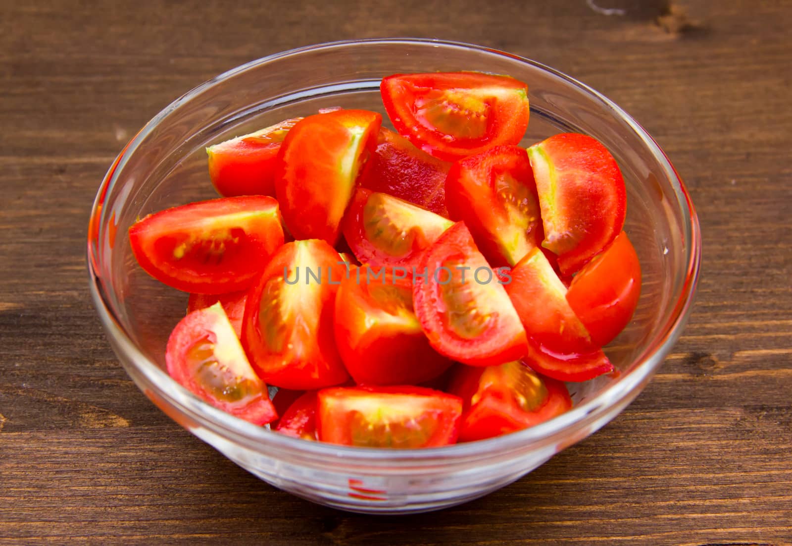 Wedges of tomato bowl on wooden table