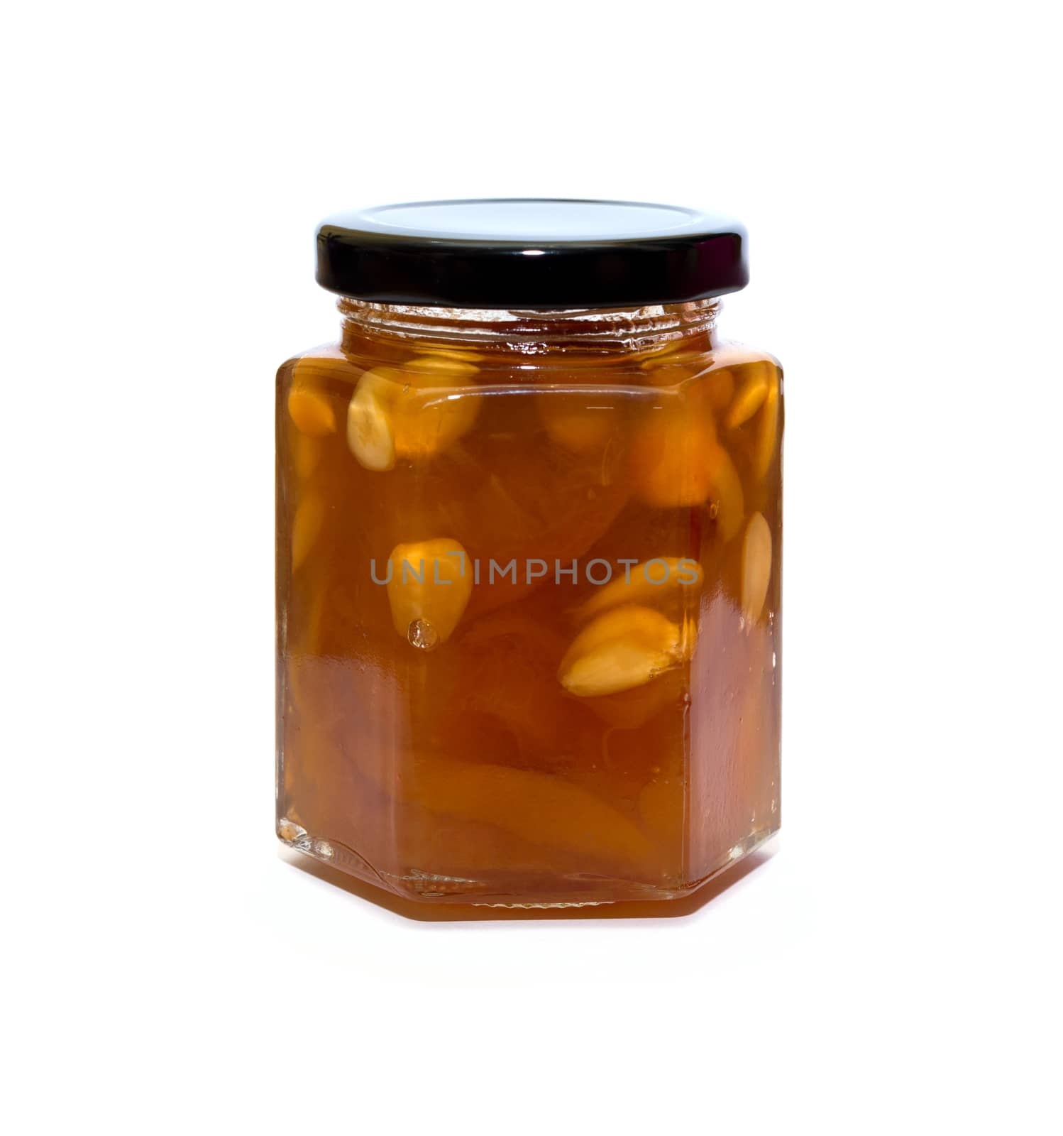 Peach jam glass jar reflected on white background