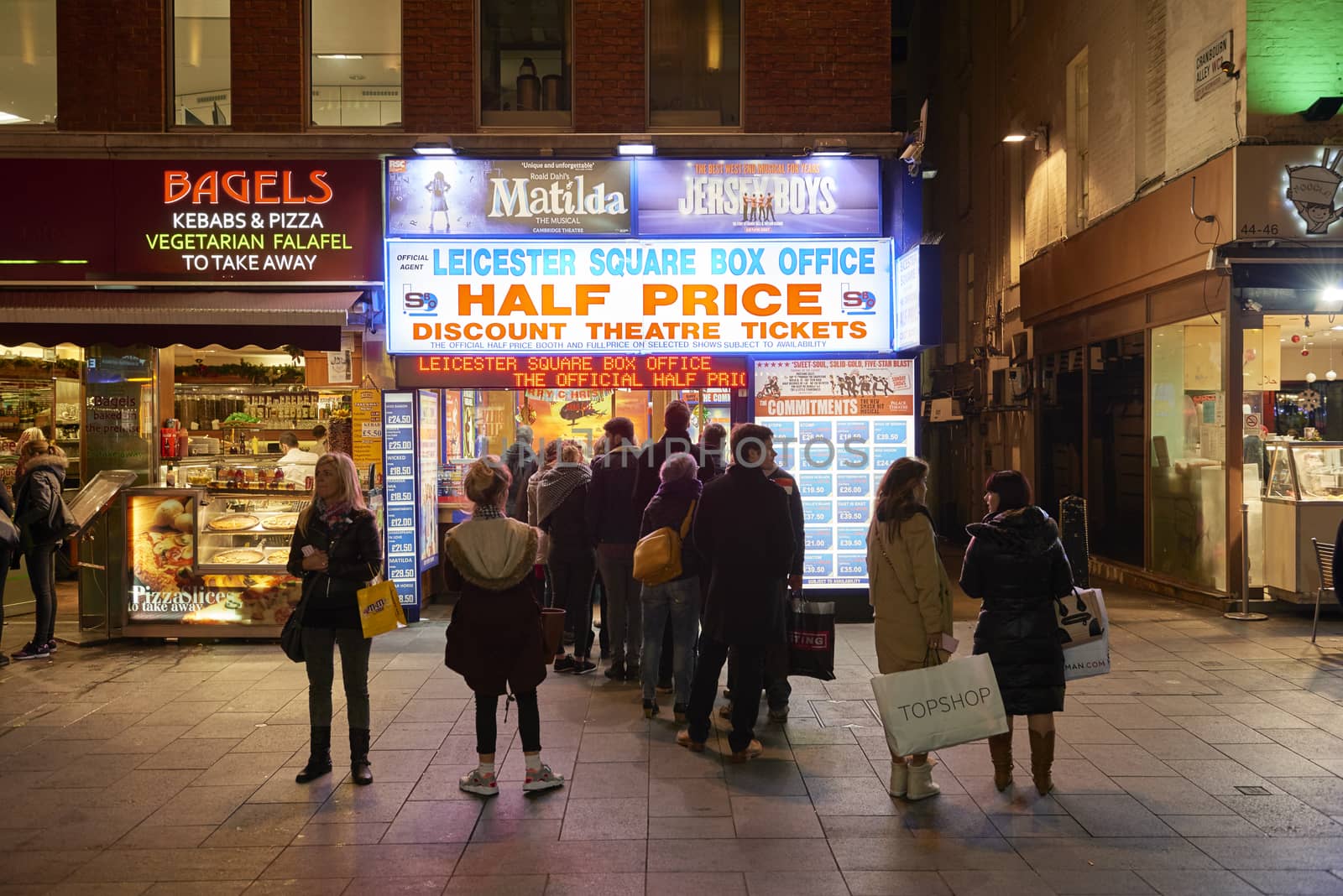 LONDON, UK - JANUARY 02: People lined up for discounted theatre tickets at night in Leicester Square. January 02, 2015 in London.