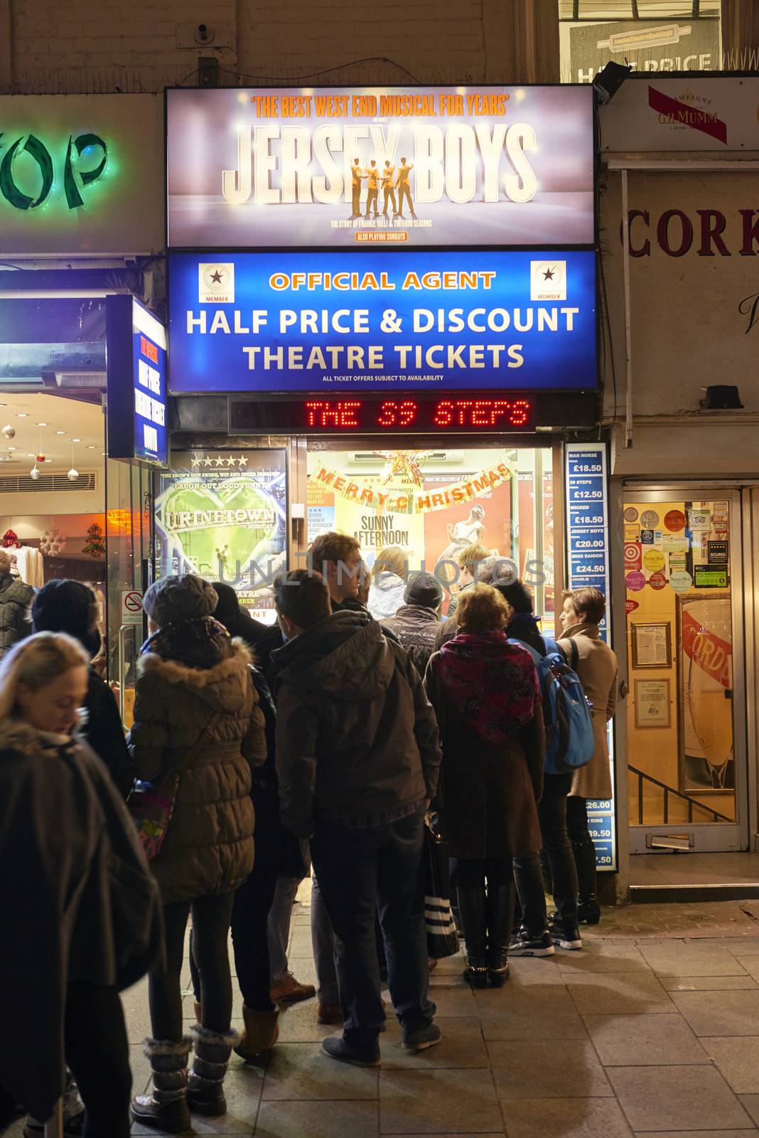 LONDON, UK - JANUARY 02: People lined up for discounted theatre tickets at night in Leicester Square. January 02, 2015 in London.