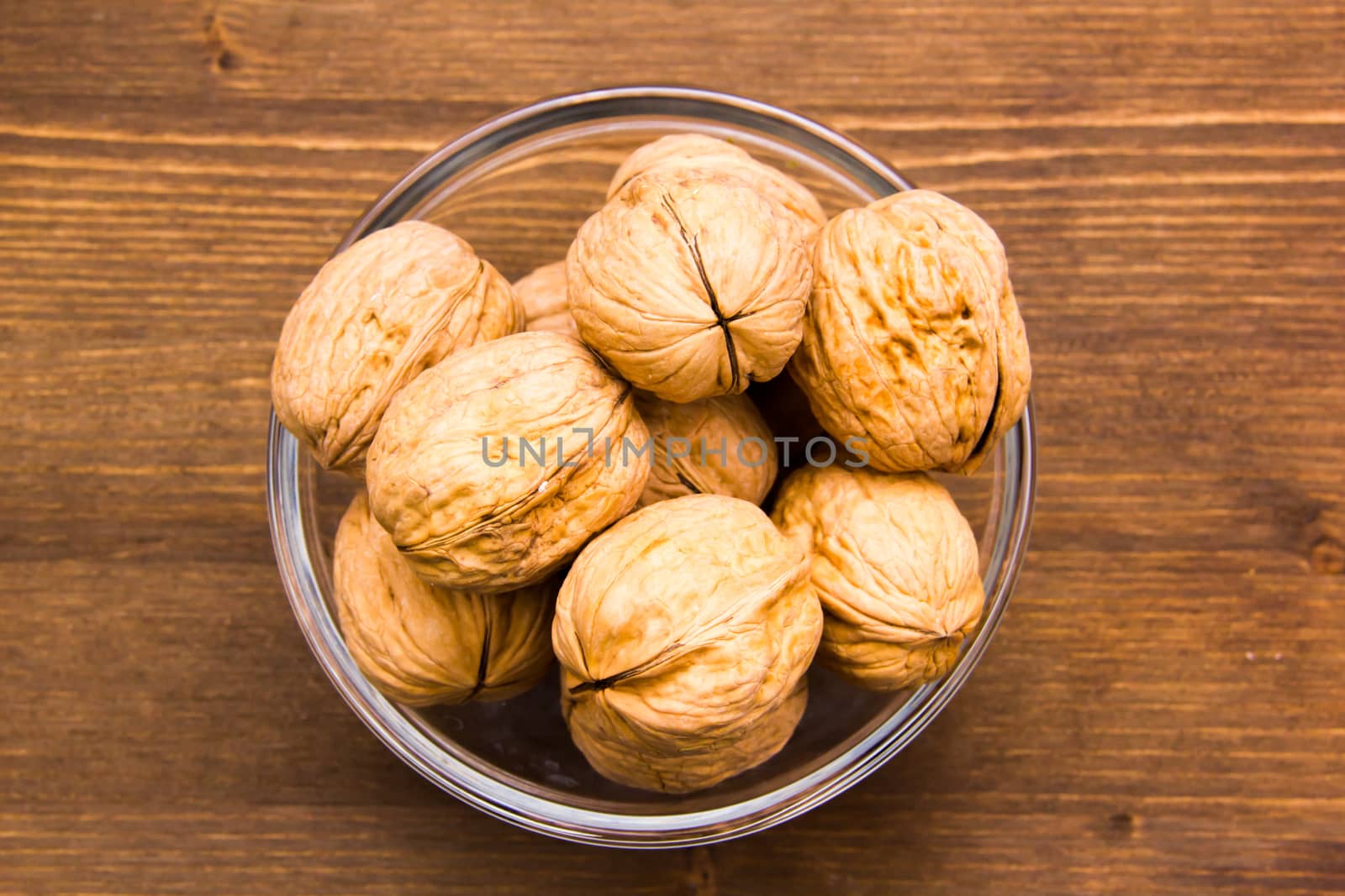 Nuts on bowl on wooden table top