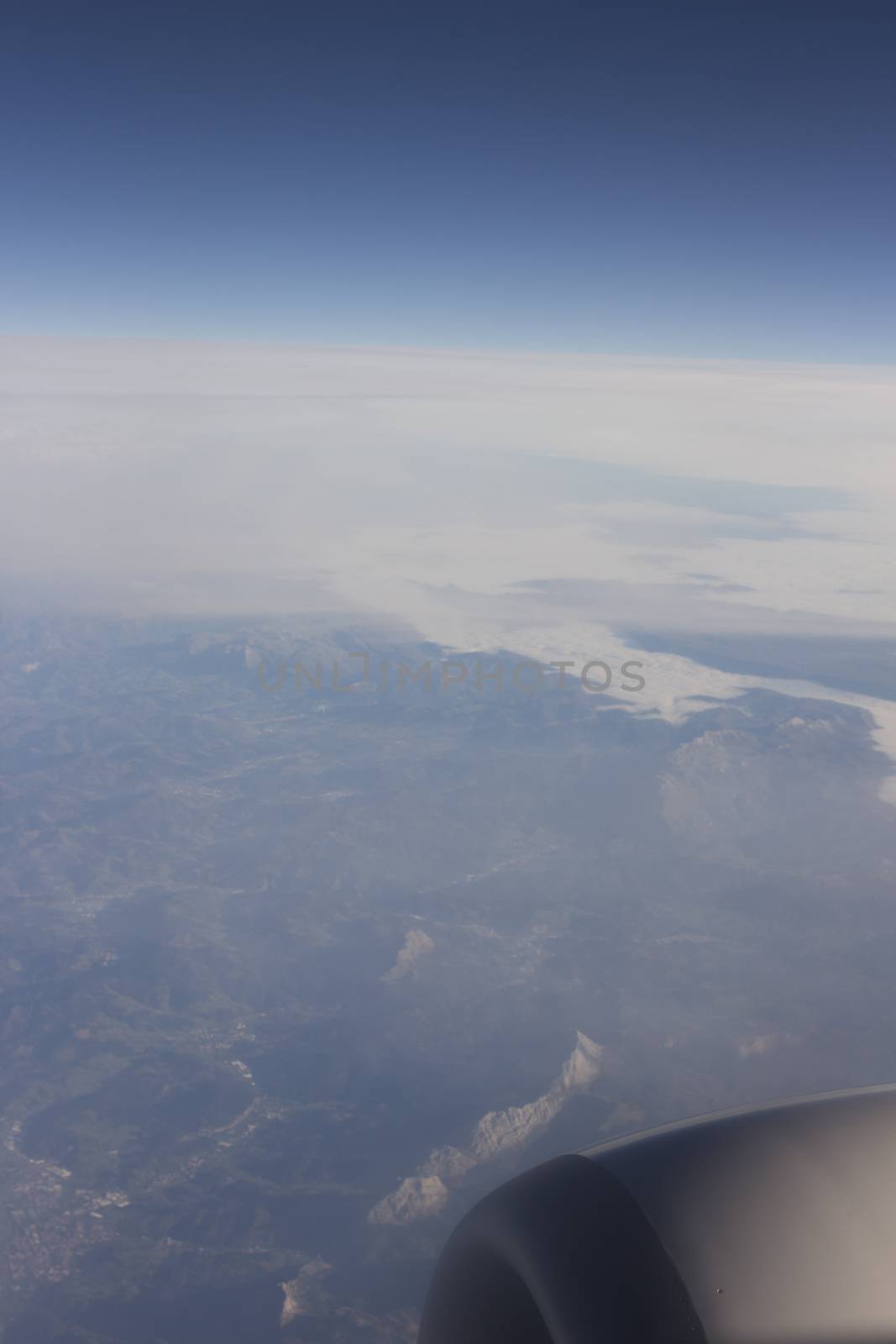 Airplane flying in sky in flight engine wing.