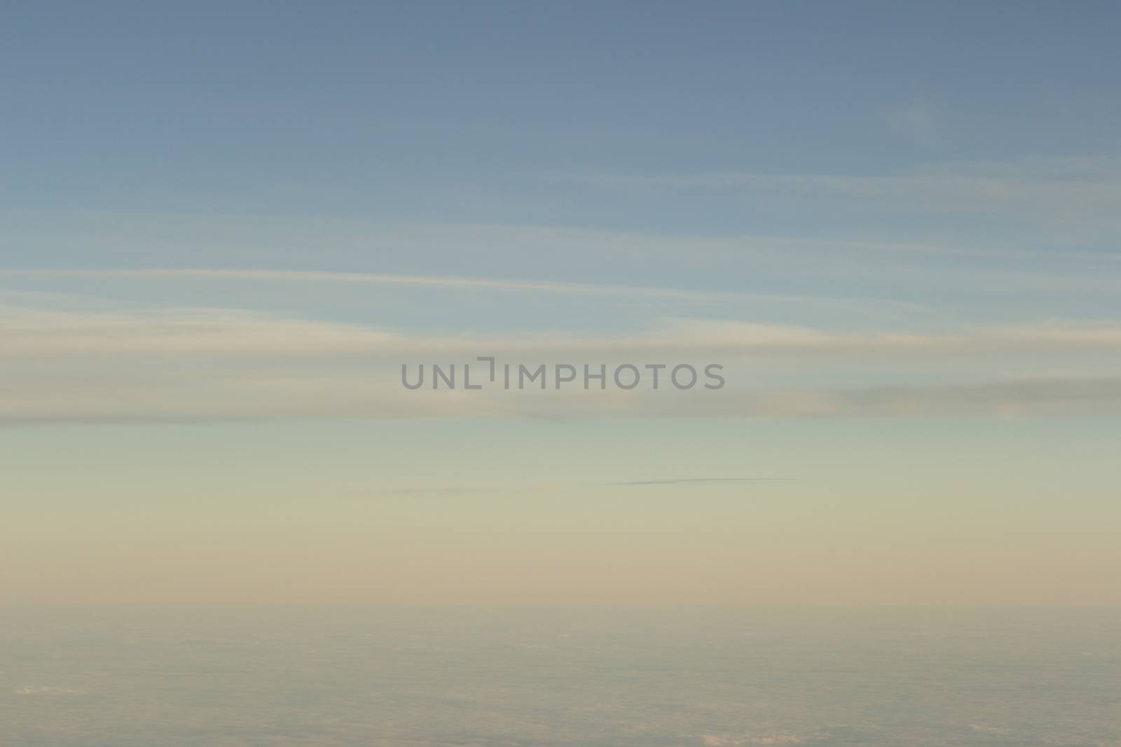 Blue sky with clouds seen from plane window by edwardolive