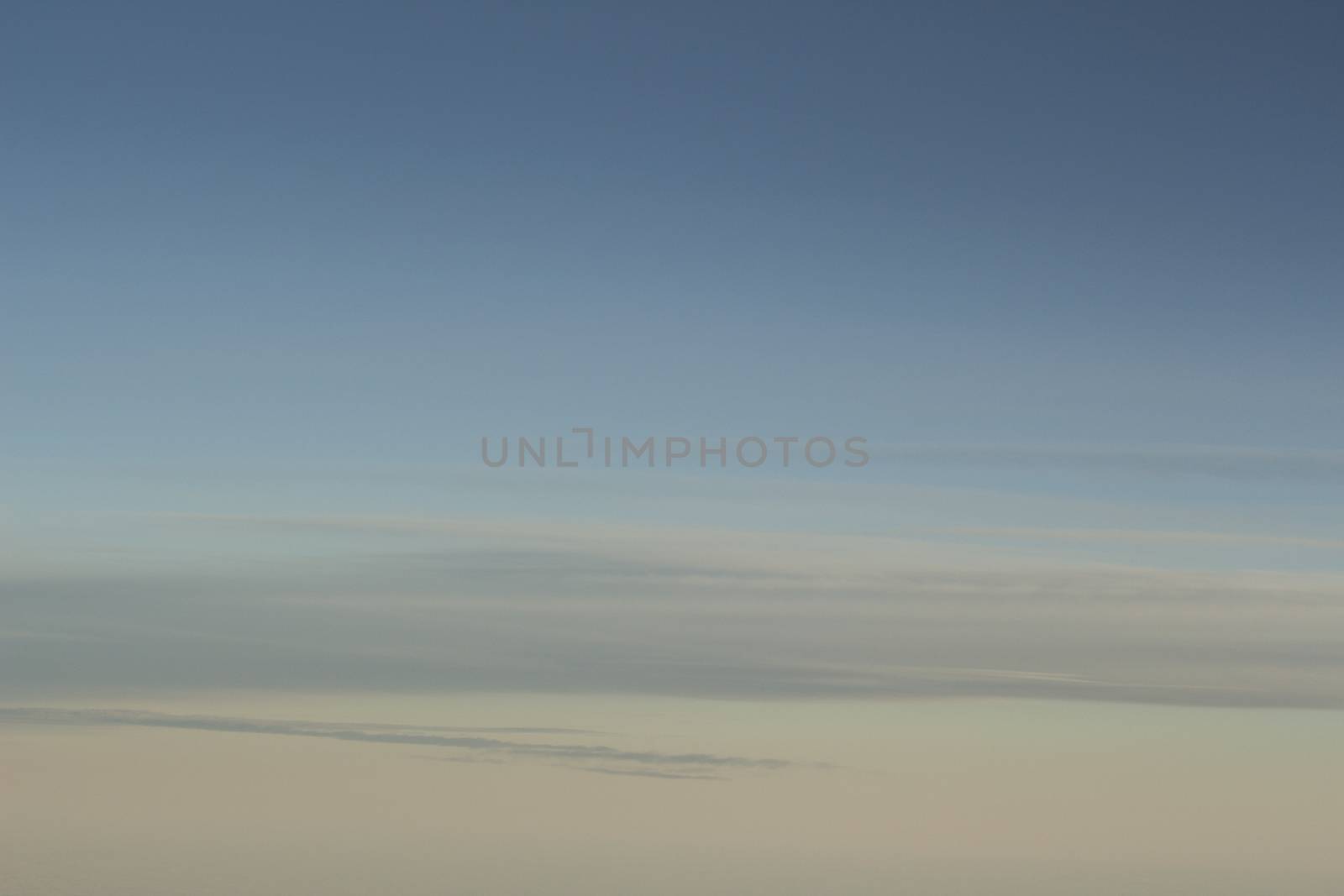 Blue sky with clouds seen from plane window by edwardolive