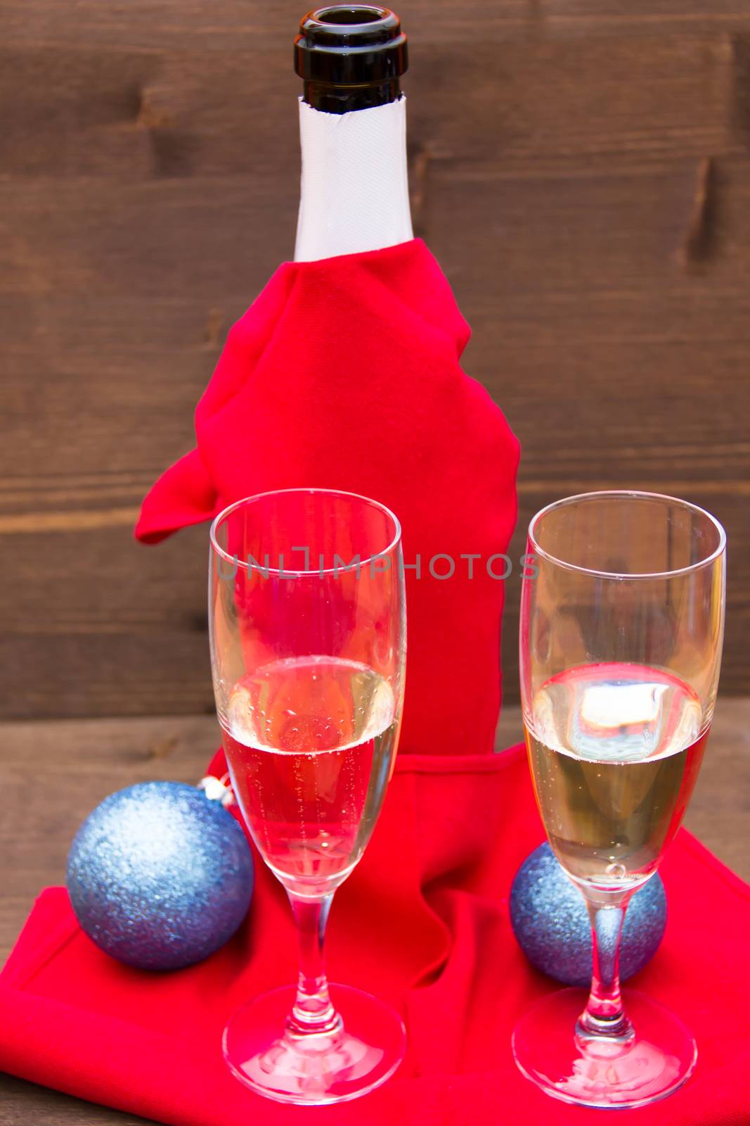 Champagne and flutes on wooden table