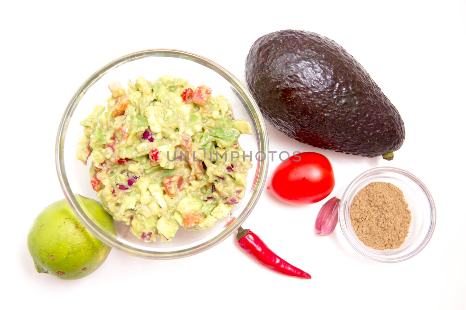 Guacamole and ingredients on white background seen from above