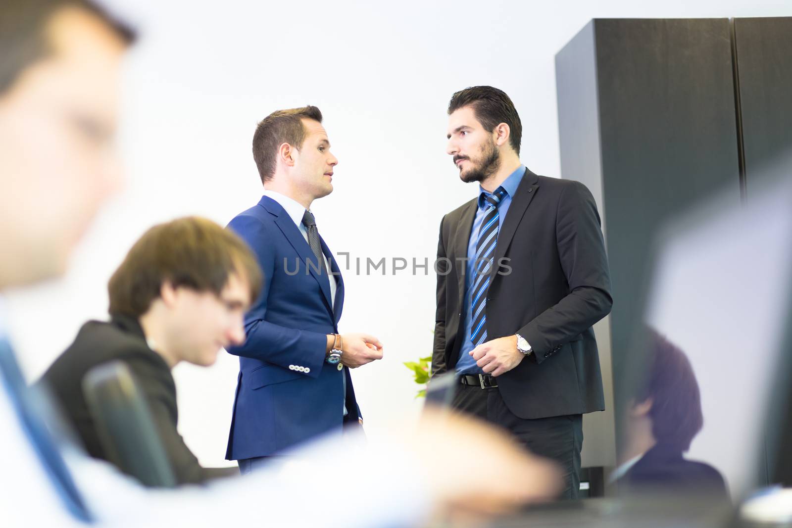 Workplace in modern office with business people brainstorming. Businessman working on laptop during the meeting.