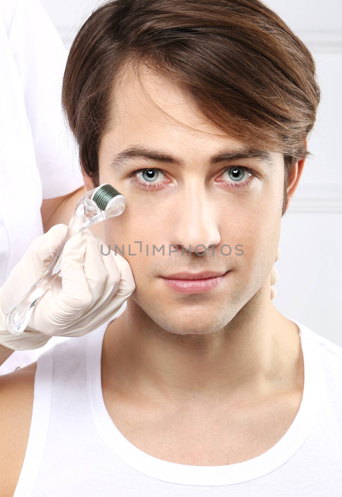 Portrait of a young man groomed during the treatment in the beauty salon