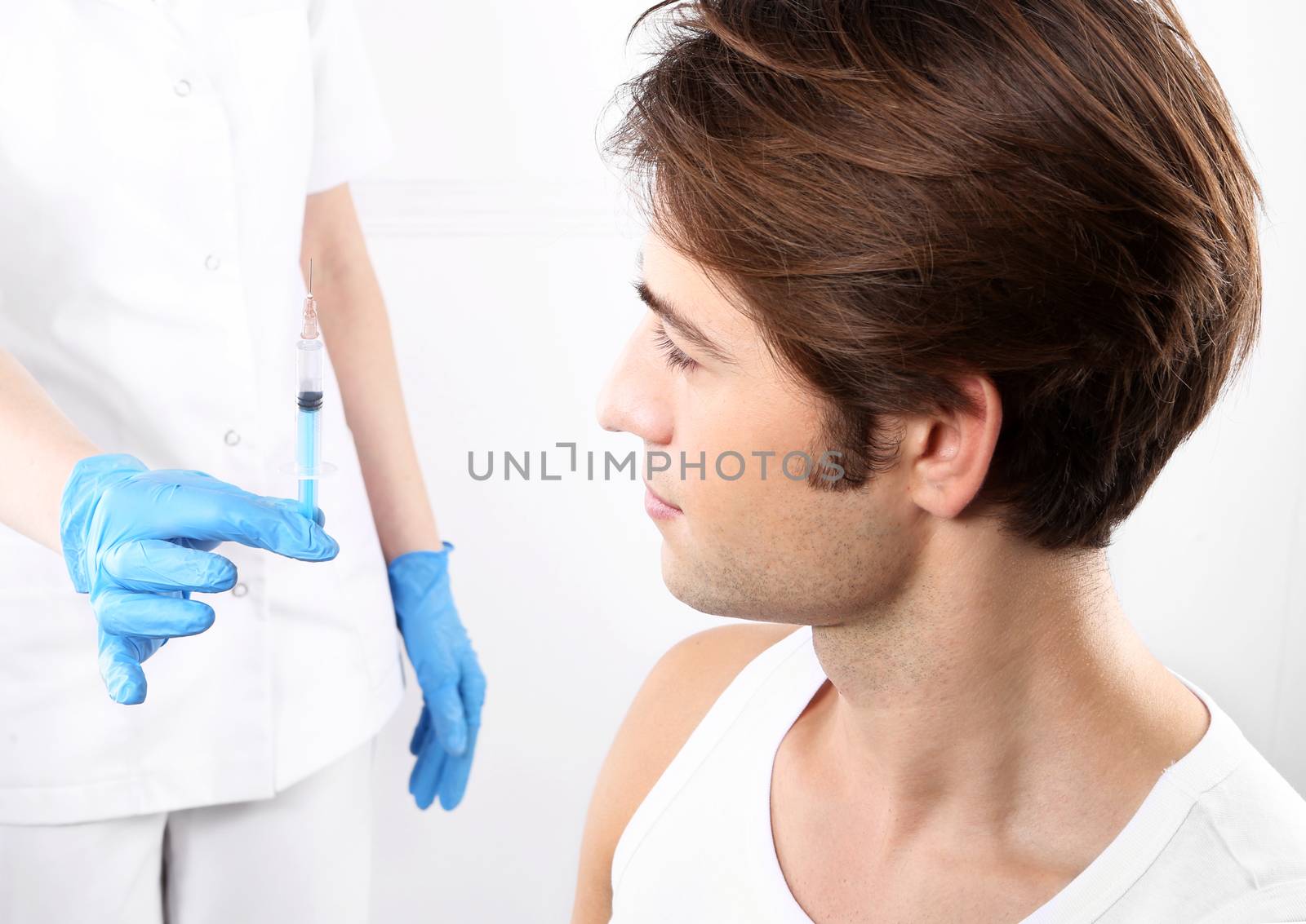 The young man is a nurse with syringe