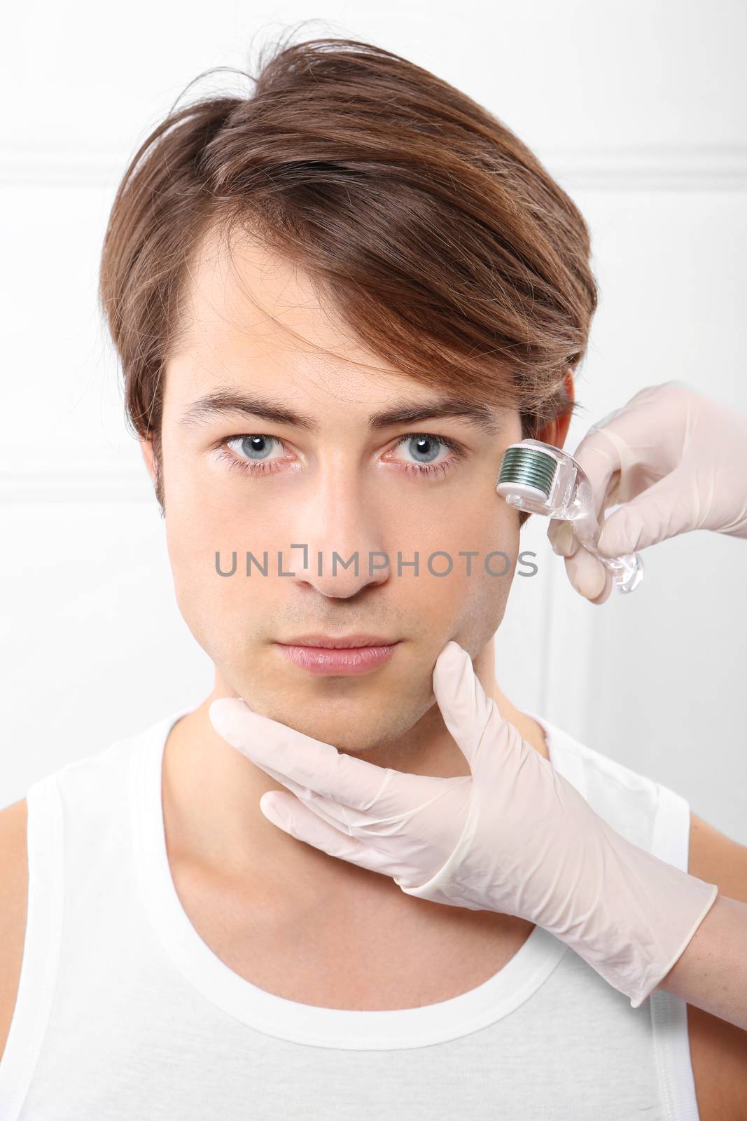Portrait of a young man groomed during the treatment in the beauty salon