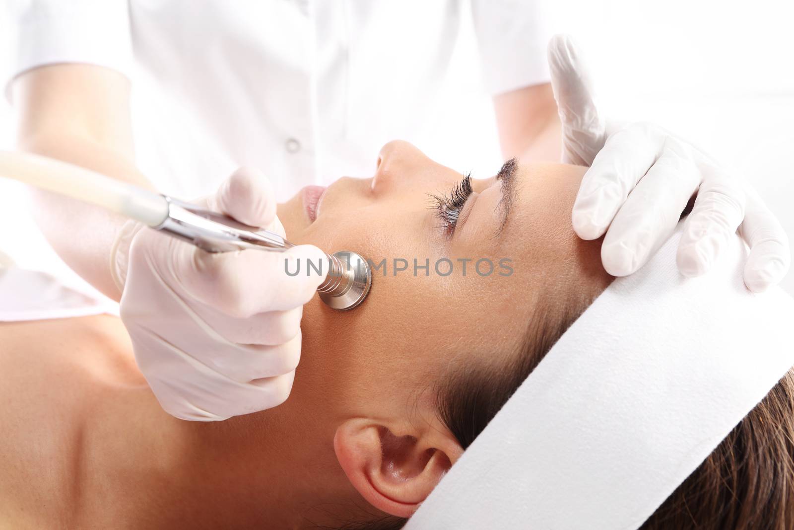 Relaxed woman during a microdermabrasion treatment in beauty salon by robert_przybysz