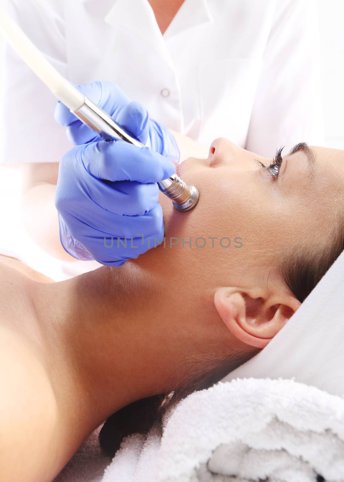 Relaxed woman during a microdermabrasion treatment in beauty salon by robert_przybysz