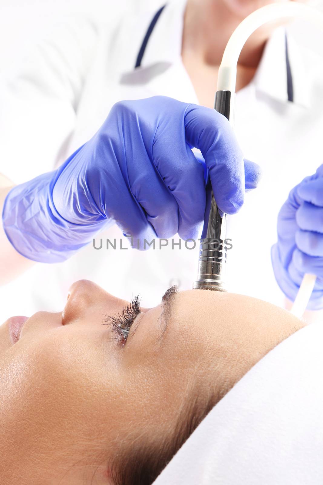 Relaxed woman during a microdermabrasion treatment in beauty salon by robert_przybysz