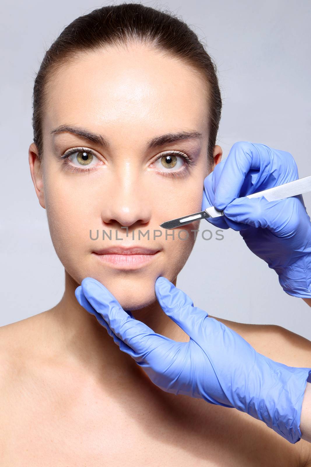 Caucasian woman during surgery using a scalpel