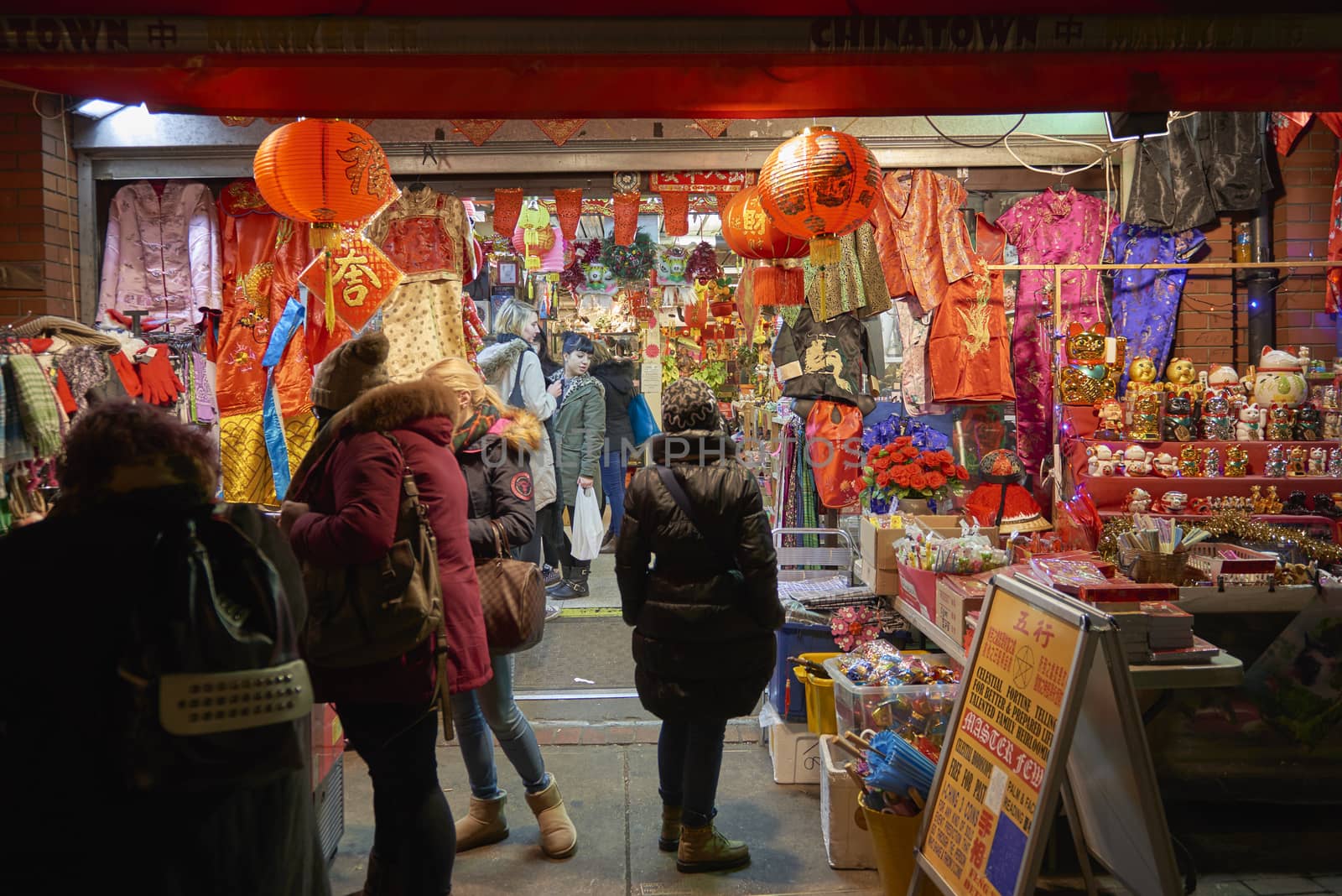 LONDON, UK - JANUARY 02: Tourists shopping at traditional Chinese store in Chinatown at night. January 02, 2015 in London.