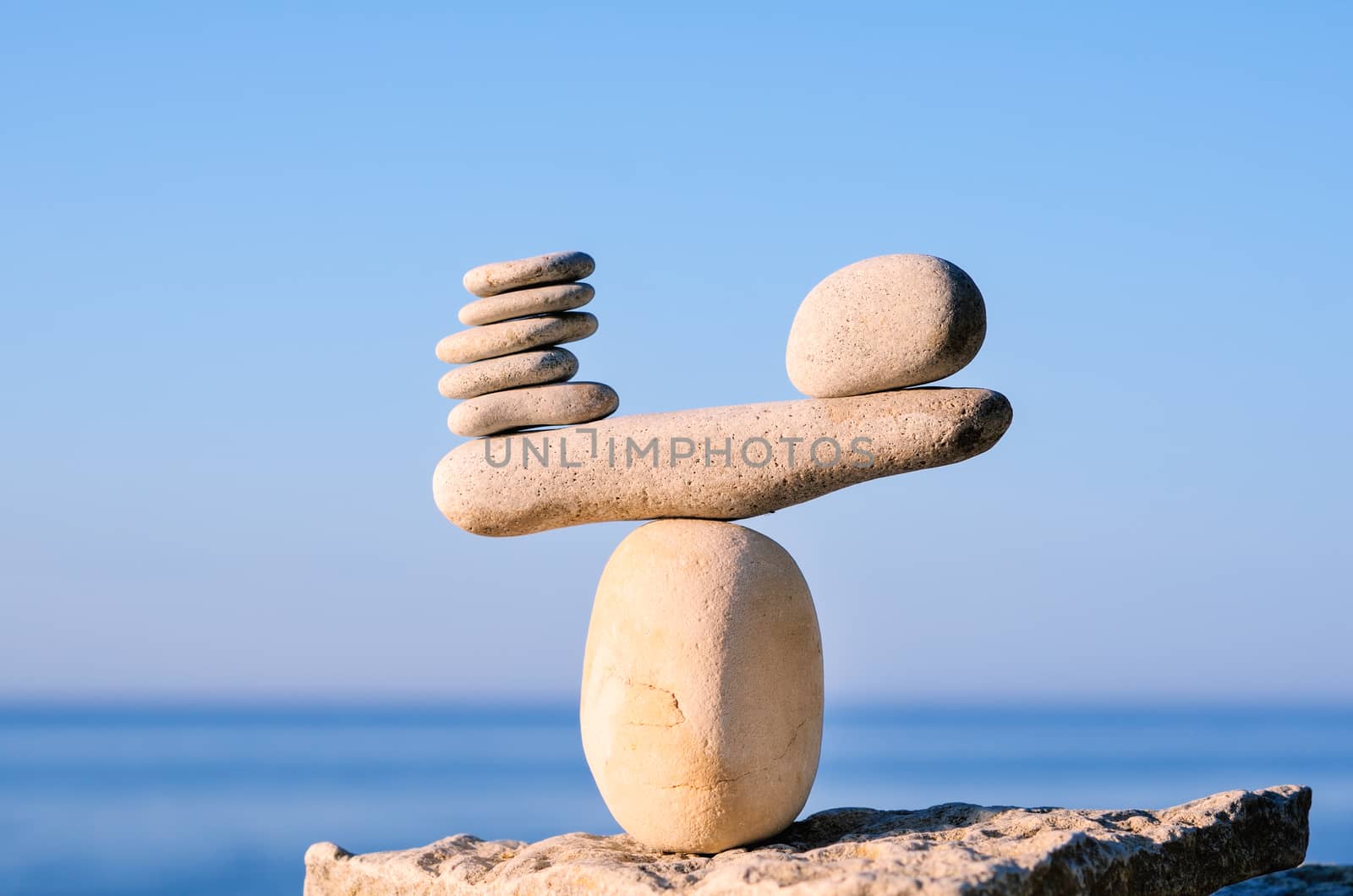 Balancing of white pebbles on the top of stone