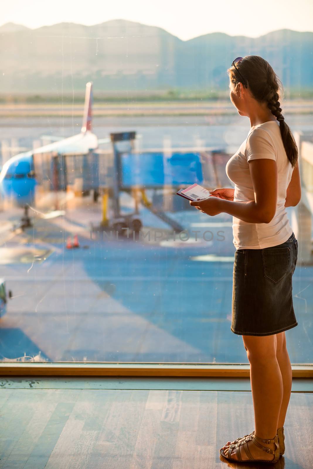 girl looks through the glass on the plane by kosmsos111