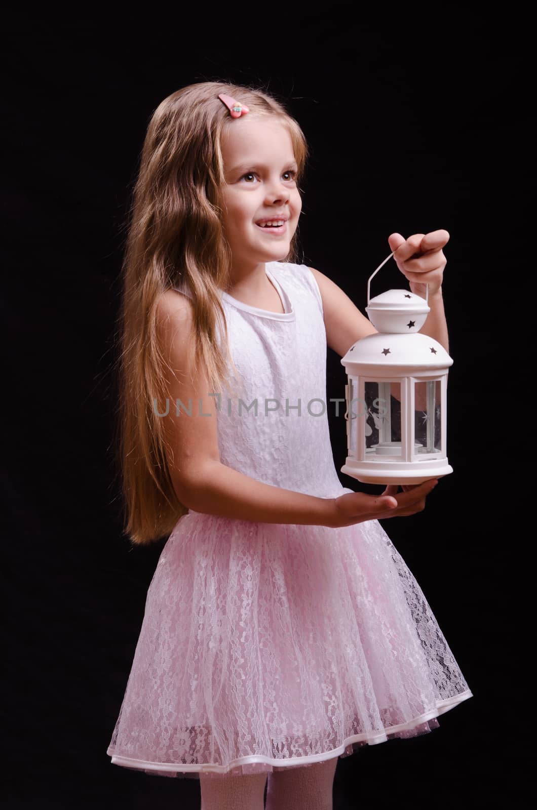 Five year old girl standing with a candlestick