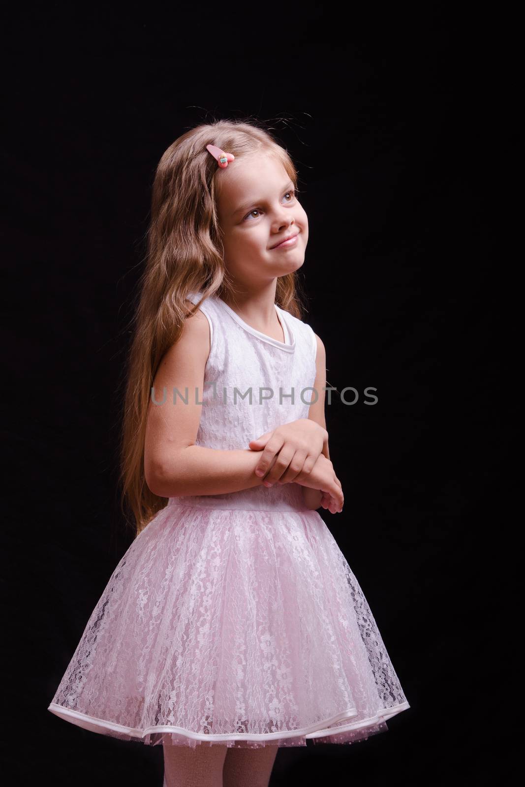 Portrait of a beautiful five year old girl on a black background