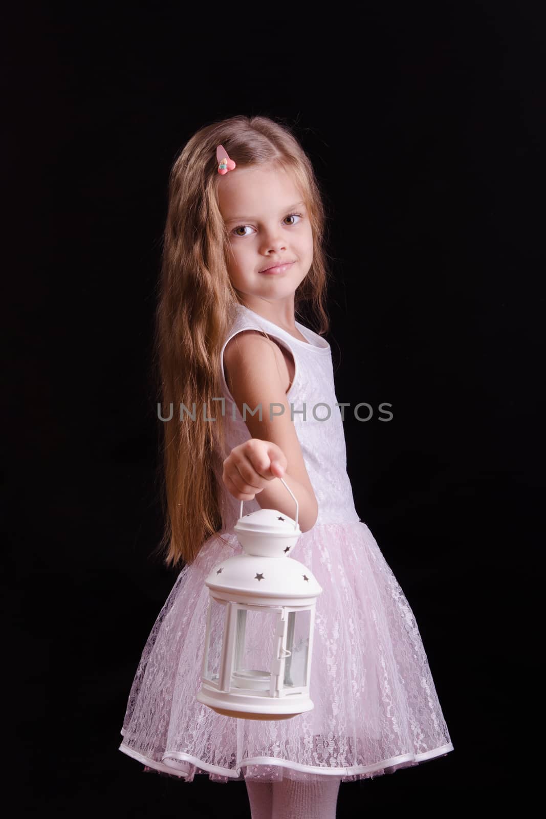 Five year old girl standing with a candlestick