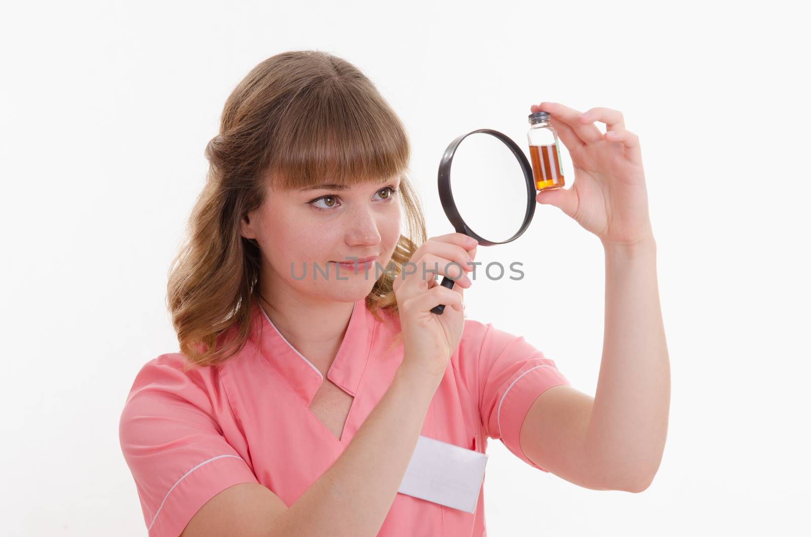 Pharmacist sitting at the table reading a thick handbook of medicines