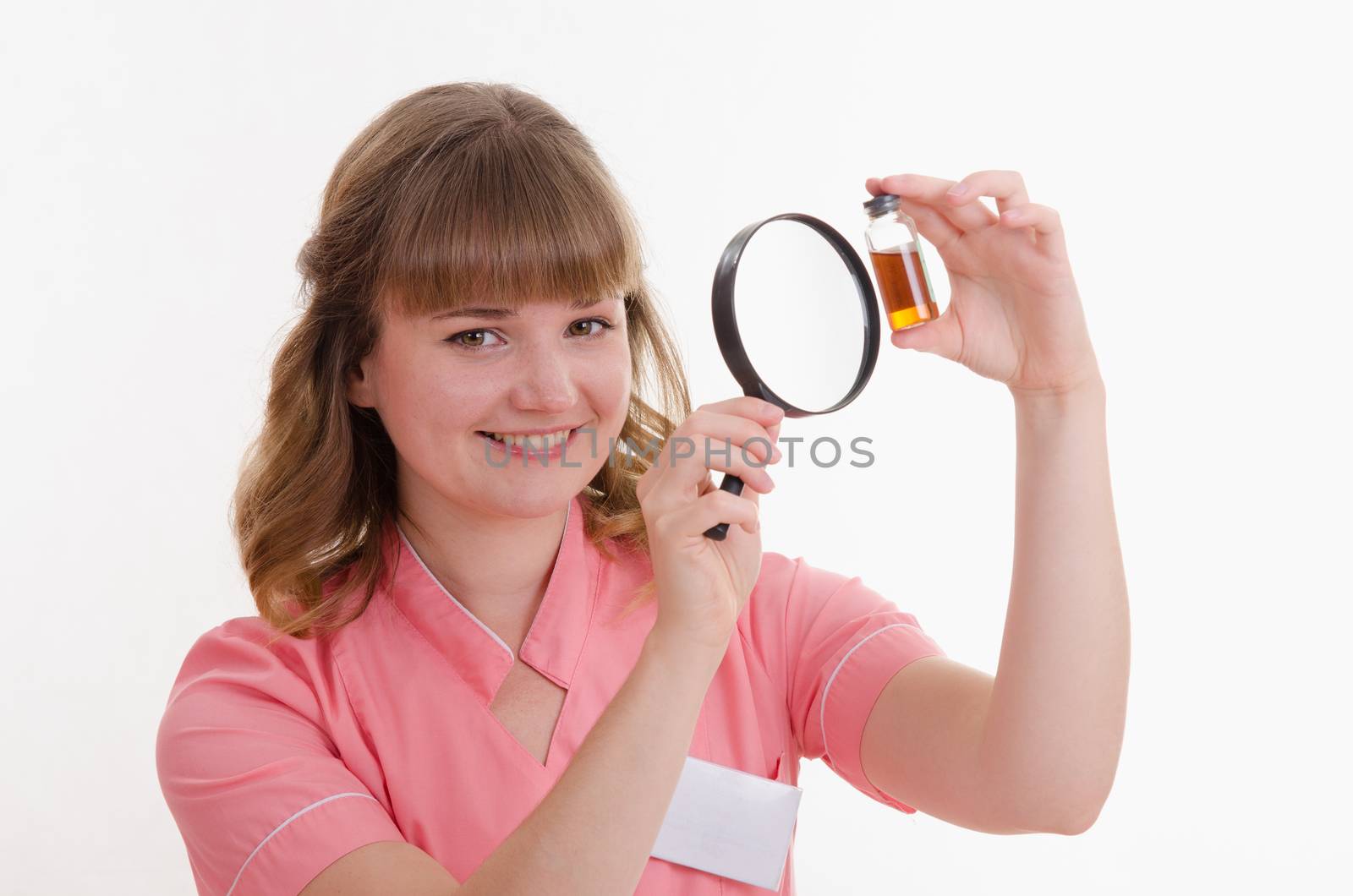 Pharmacist sitting at the table reading a thick handbook of medicines