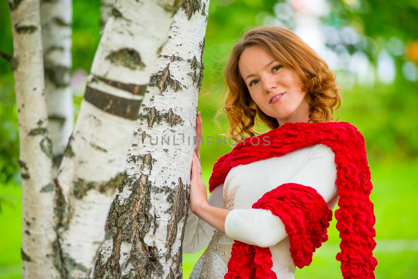 Horizontal portrait of a beautiful girl on nature near the tree