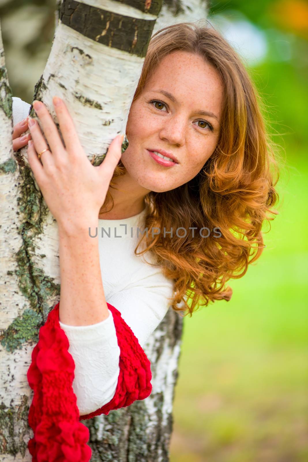 portrait of a beautiful slim girl near the birch