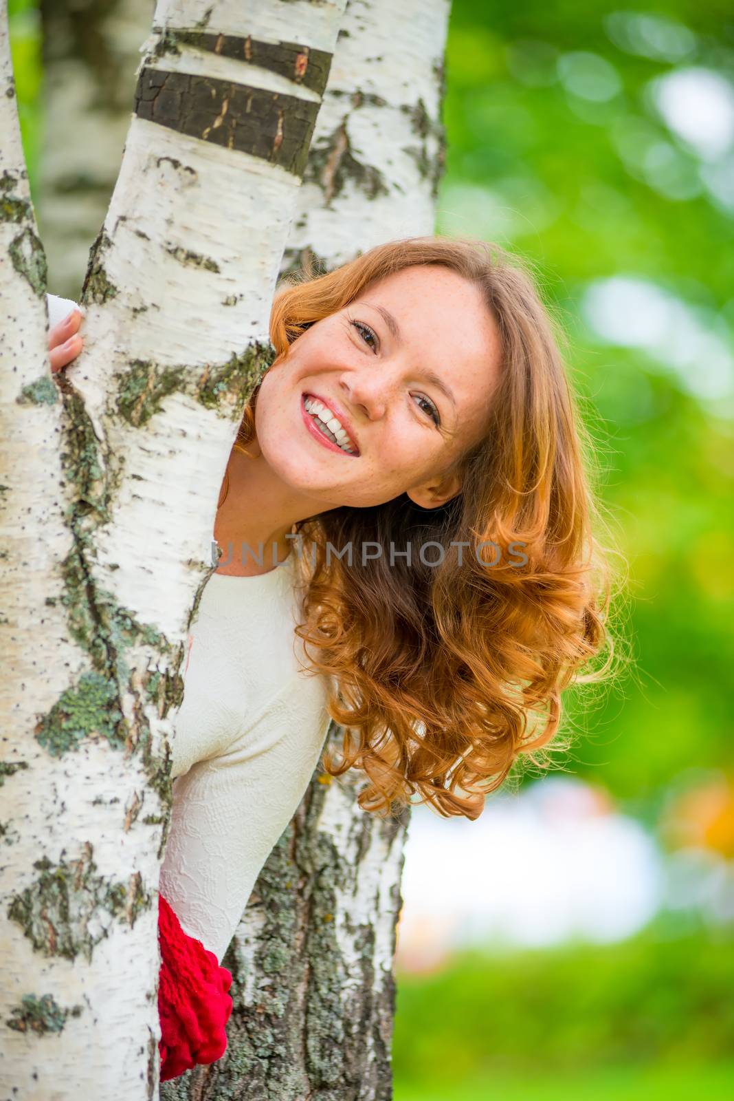 fun and playful girl in white dress among the trees by kosmsos111