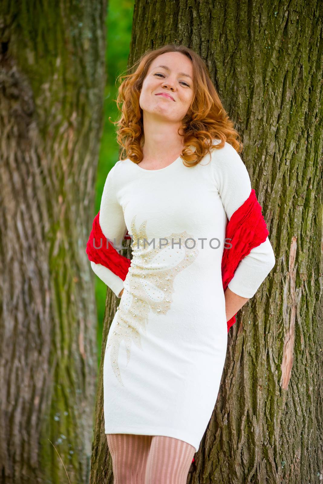 smiling woman on the background of the trunks of old trees by kosmsos111