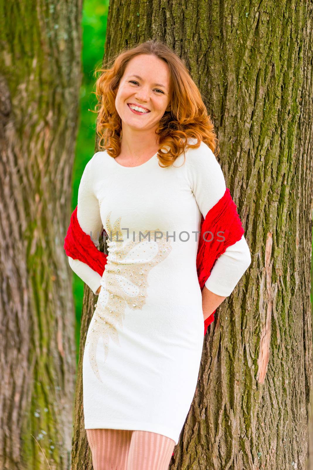 portrait of happy girl near old trees in the park by kosmsos111