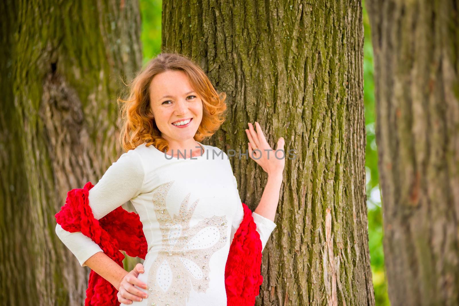 brown-eyed red-haired beautiful girl portrait in the park