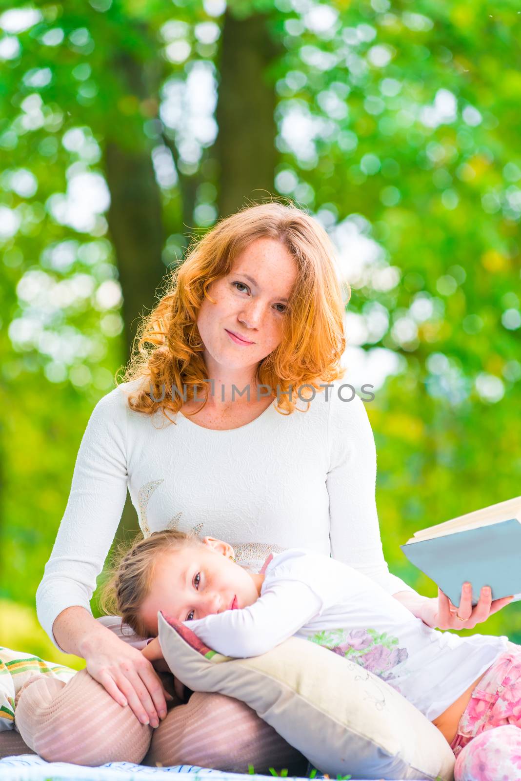 Vertical portrait of a mother and daughter in the park