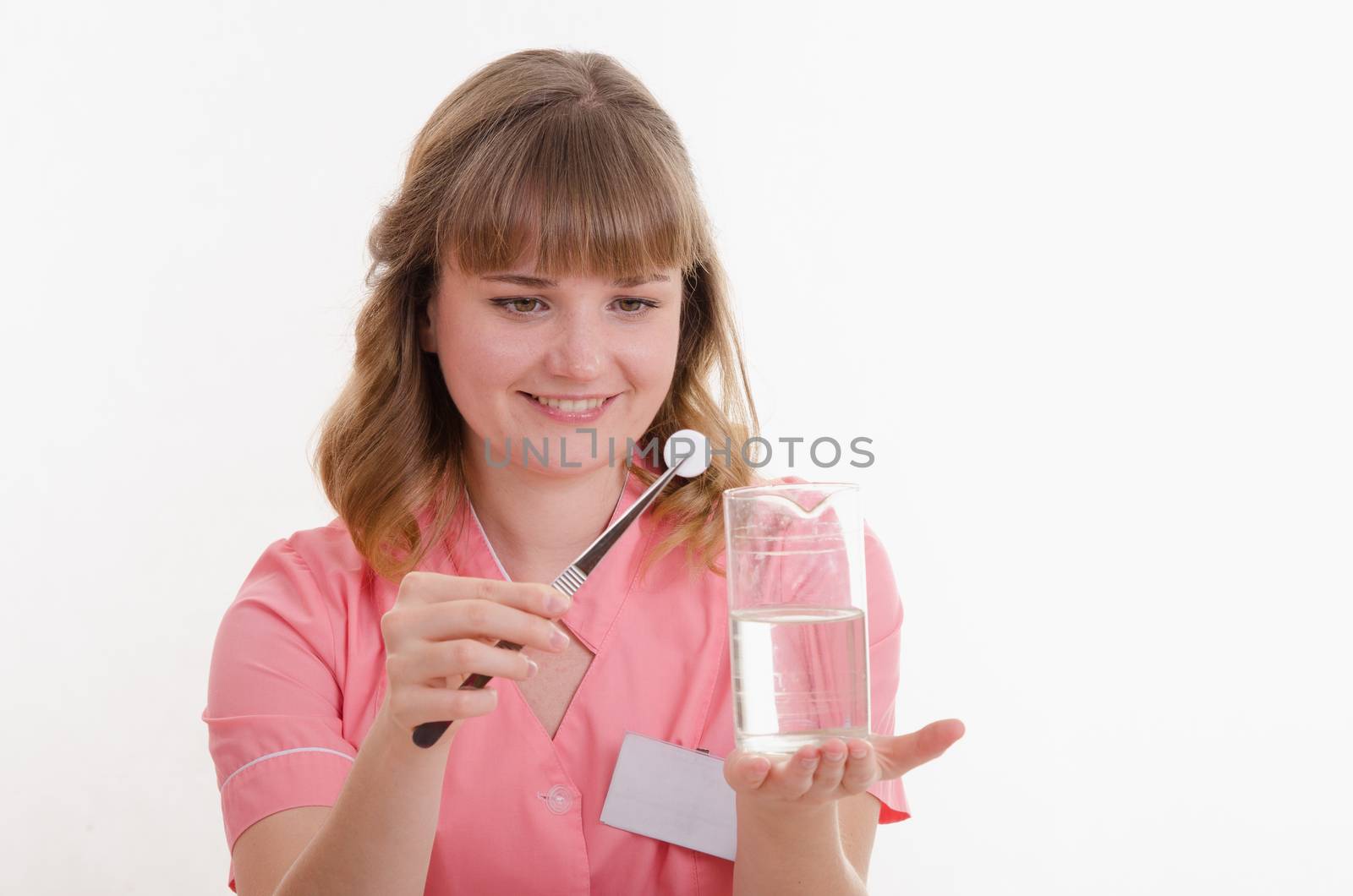Pharmacist sitting at the table reading a thick handbook of medicines