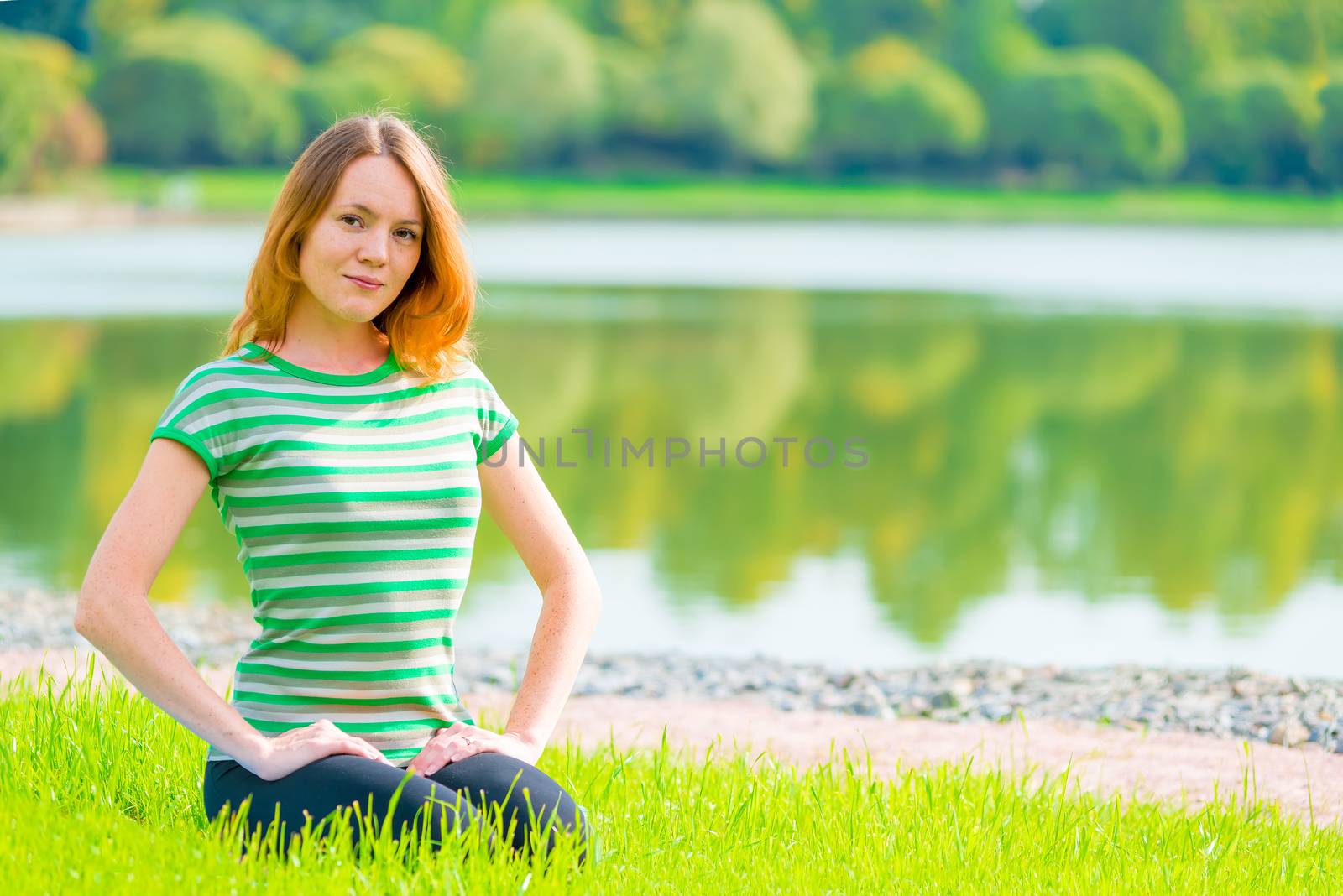 young girl sitting on the grass and beautiful smiles