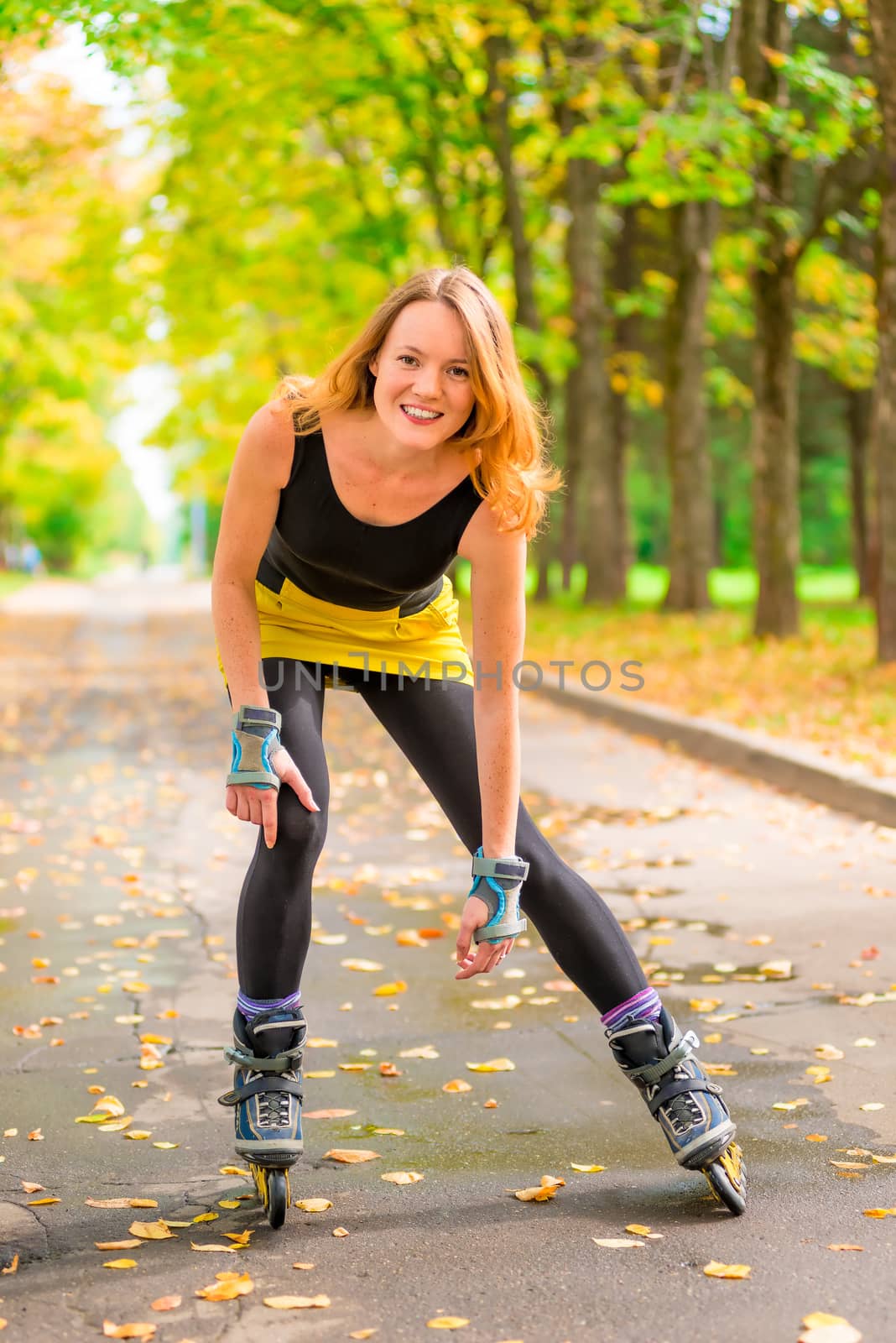 athlete posing on skates in the autumn deserted park by kosmsos111