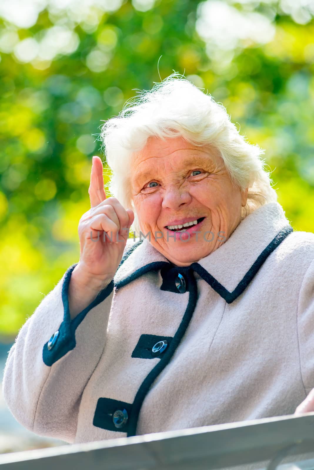 happy grandmother is resting on a park bench