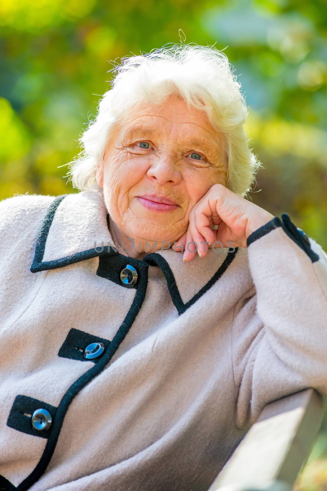 Smiling elderly pensioner rest on the nature in the park