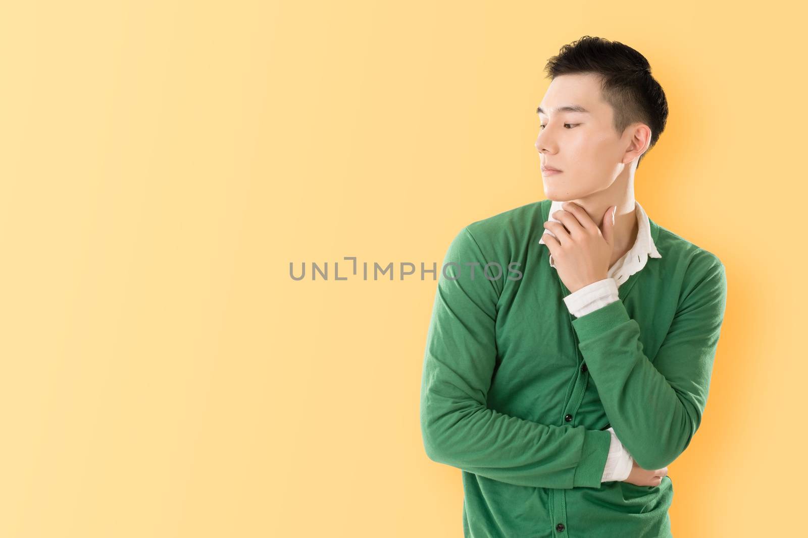 Sensitive Asian young man, closeup portrait with colorful background.