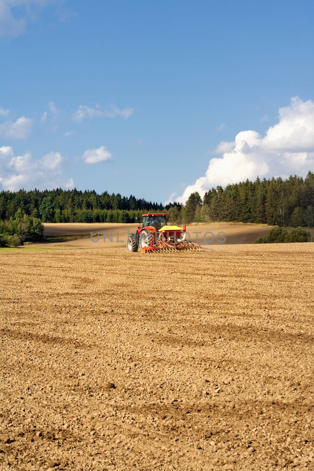 farmer on tractor plowing the field in southern bohemia