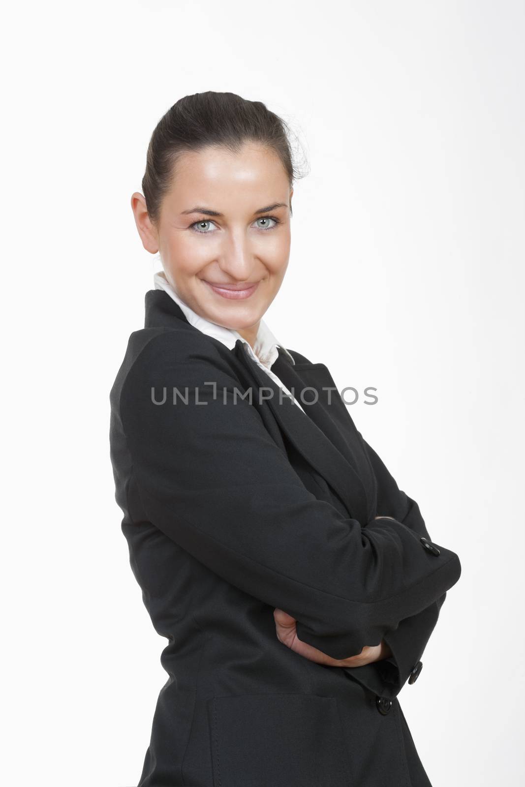 young beautiful businesswoman with her arms crossed looking at camera